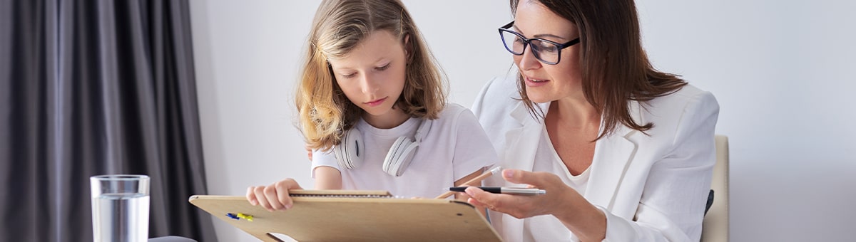 School psychologist with a student participating in an exercise.
