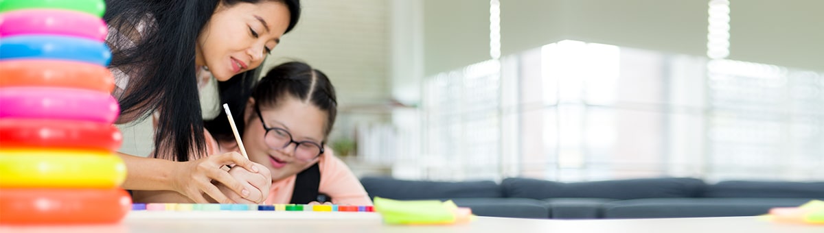 Special education teacher working with a student.